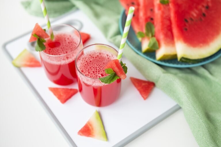 A glass of freshly squeezed fresh watermelon juice, a healthy watermelon and mint leaf smoothie.